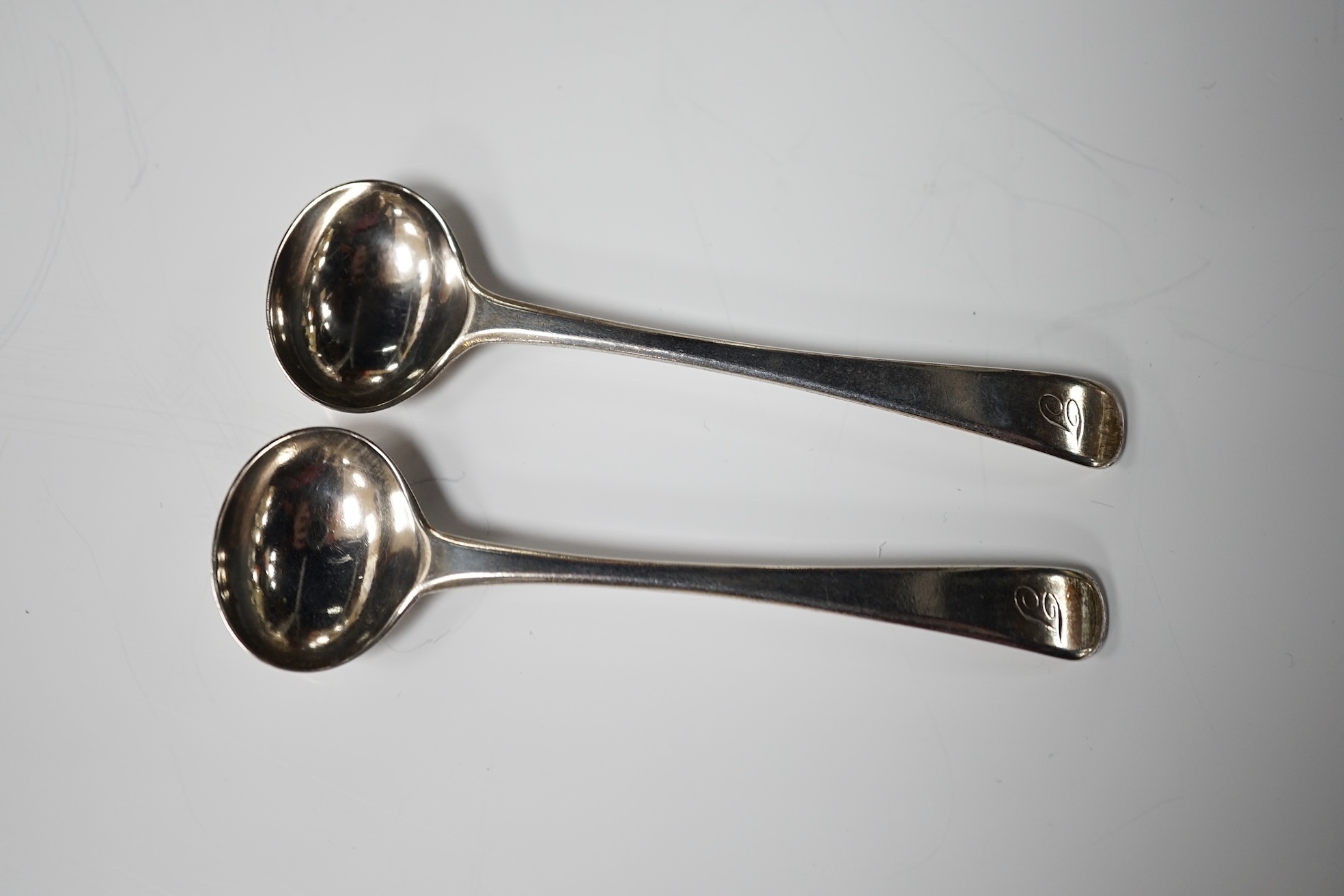 A pair of George III silver cauldron salts, London, 1765, with a pair of later Georgian mustard ladles, together with a late Victorian silver sauceboat. Condition - fair to good